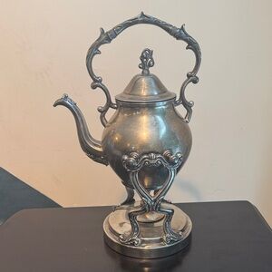 Elegant Silver Teapot with Ornate Handle